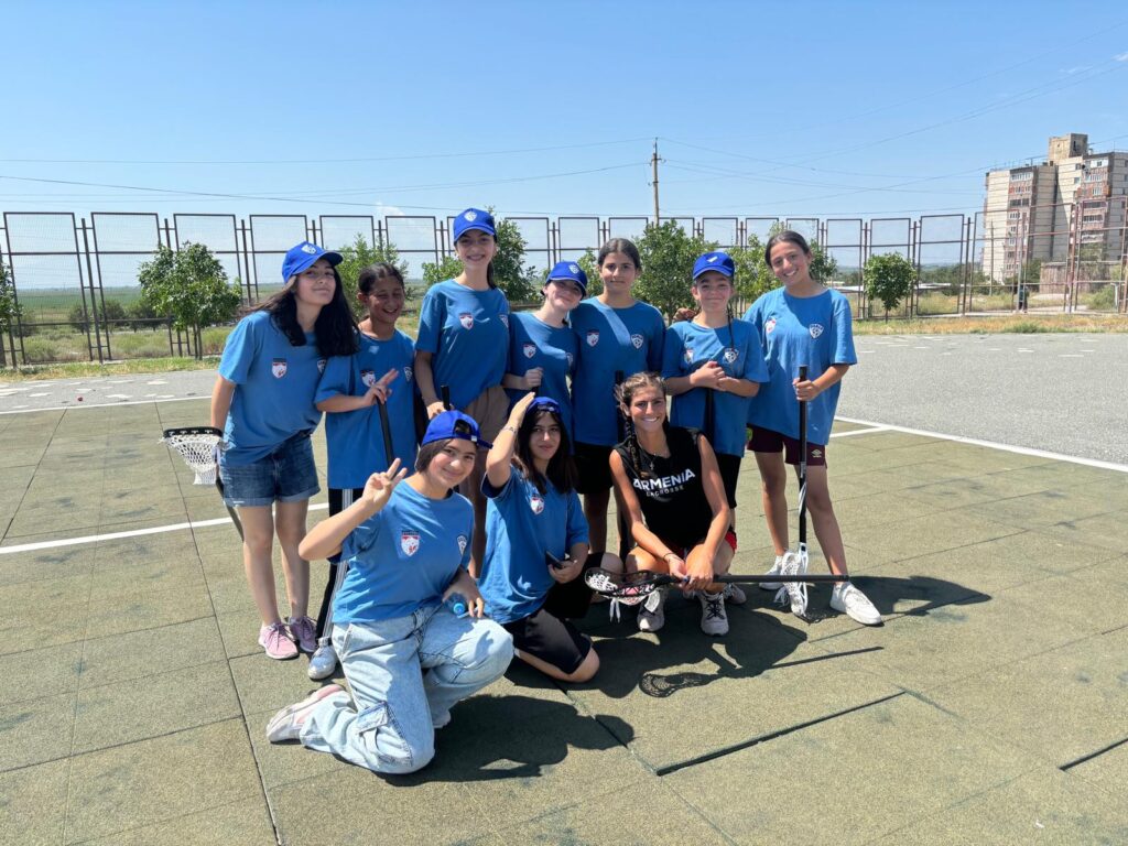 Sadie Martiesian in her black Armenia shirt takes a timeout with her new lacrosse players at Metsamor, Armenia. Credit: Courtesy of Sadie Martiesian